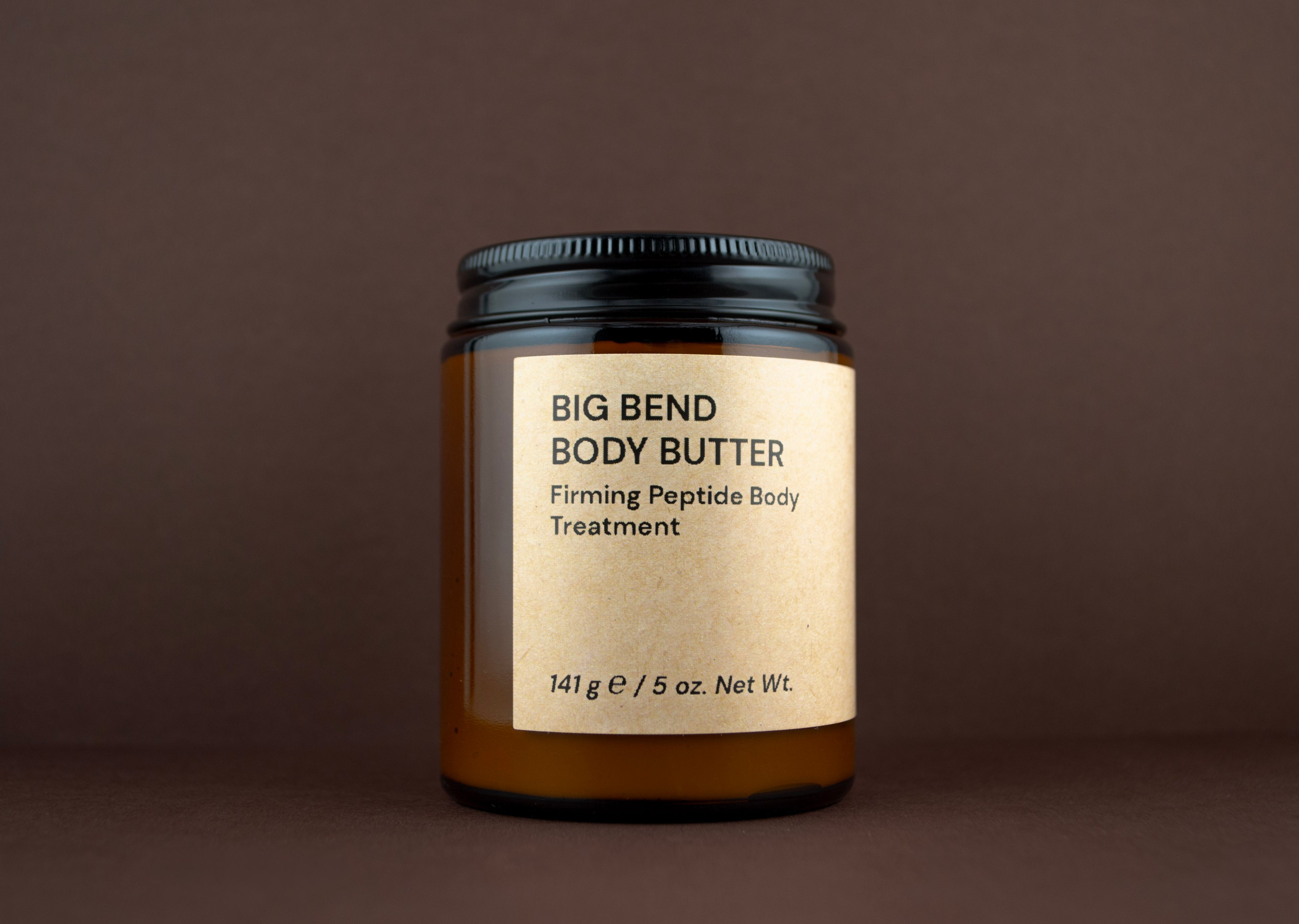 Front view of Big Bend Body Butter Firming Peptide Body Treatment (141 g / 5 oz.) in an amber glass jar.