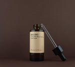 Open bottle of Brooks 2.5% AHA liquid exfoliant showing the glass dropper pipette resting on the rim.
