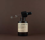 Open bottle of Cactus Nectar Vitamin C brightening oil showing the glass dropper pipette resting on the rim.