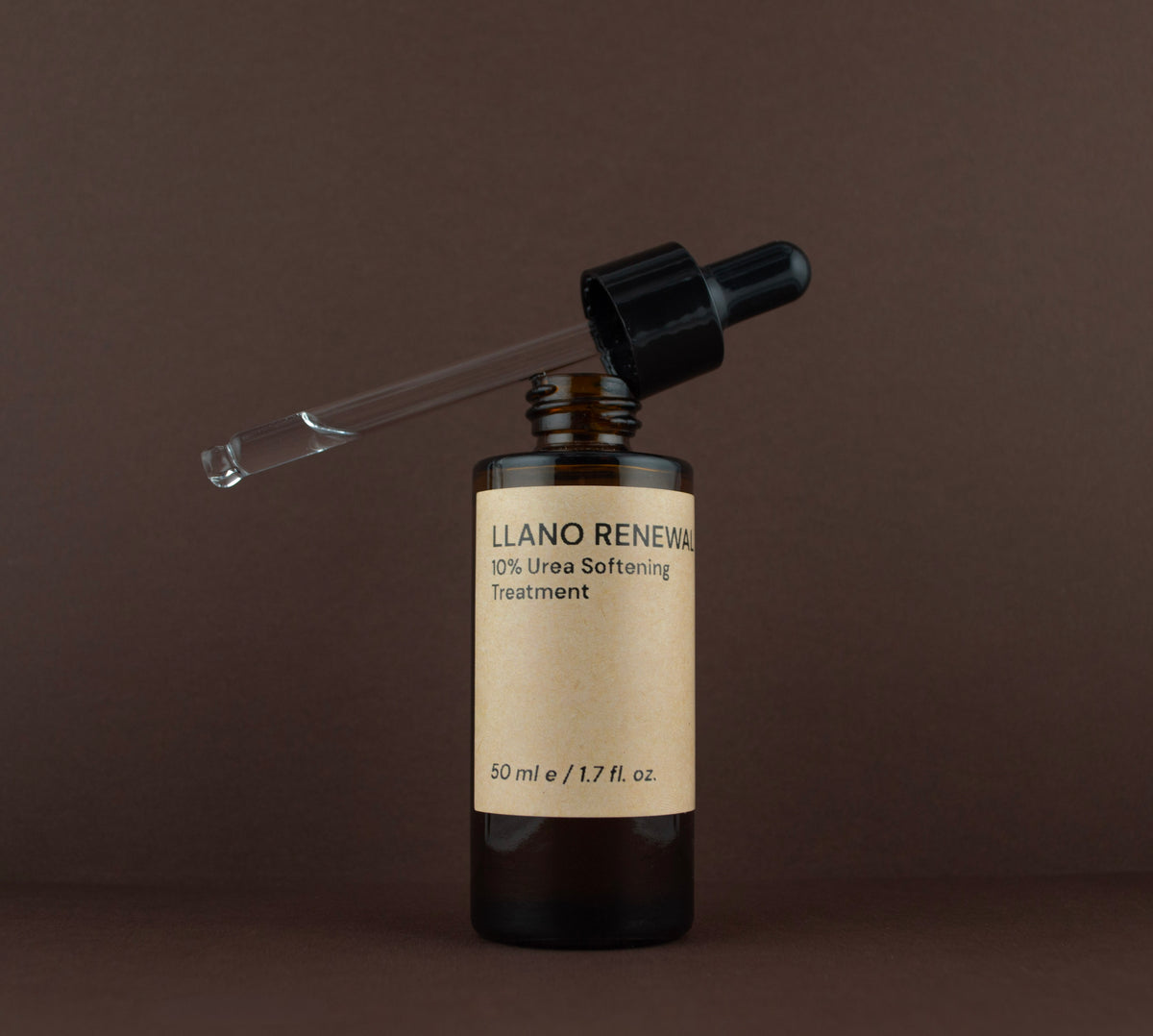 Open bottle of Llano Renewal 10% Urea softening treatment showing the glass dropper pipette resting on the rim.
