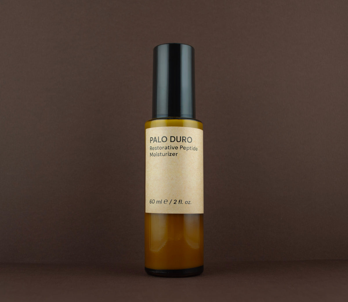 Front view of Palo Duro Restorative Peptide Moisturizer (60 ml / 2 fl. oz.) in an amber glass bottle.